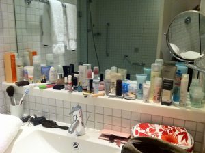 CLUTTERED AND DISORGANIZED SMALL BATHROOM WITH REGULAR MIRROR