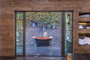 bathroom with outdoor bathtub