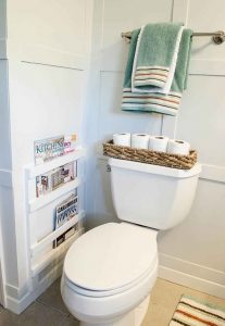 skinny storage beside he toilet in bathroom design