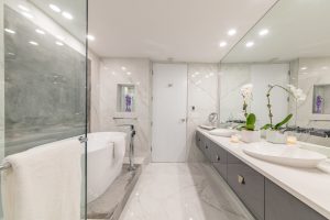 white bathroom design with bathtub and floating vanity