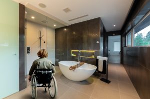woman in wheelchair in accessible bathroom design