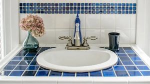 blue glass tile around bathroom sink